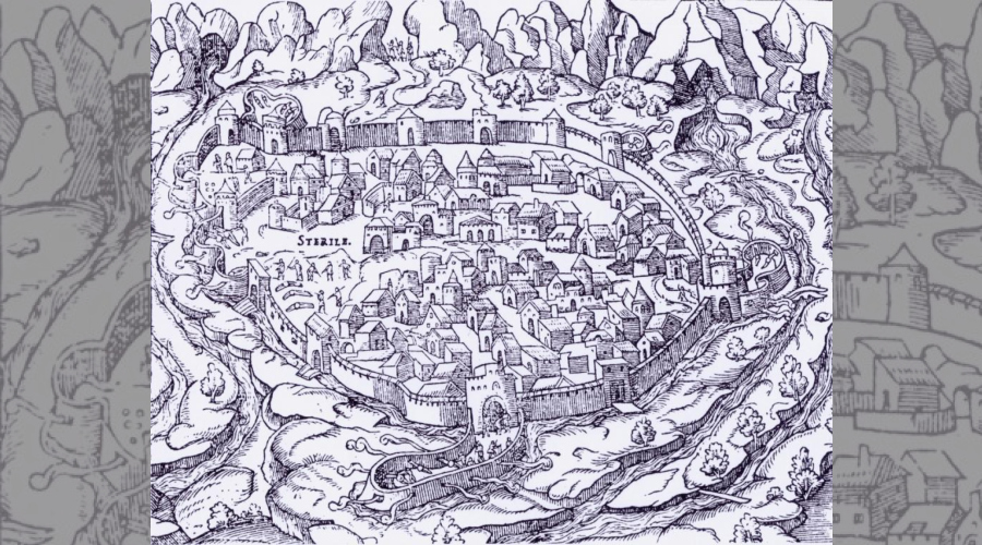  Perpignan vue du Nord avec une enceinte crénelée , le bastion du castillet, la tête en avant et des montagnes en fond