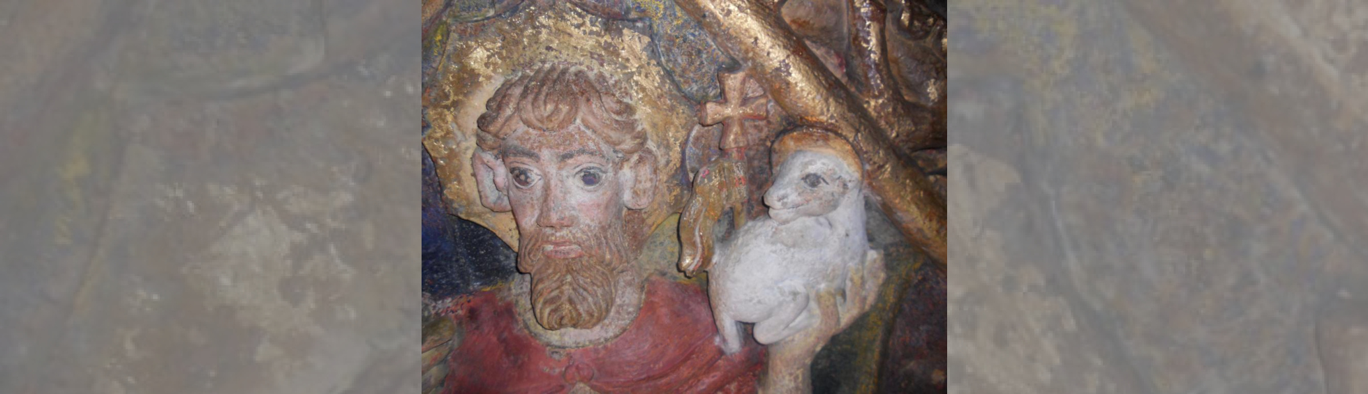 Détail d'une clé de voûte sculptée:tête de saint Jacques portant l'agneau dans sa main gauche